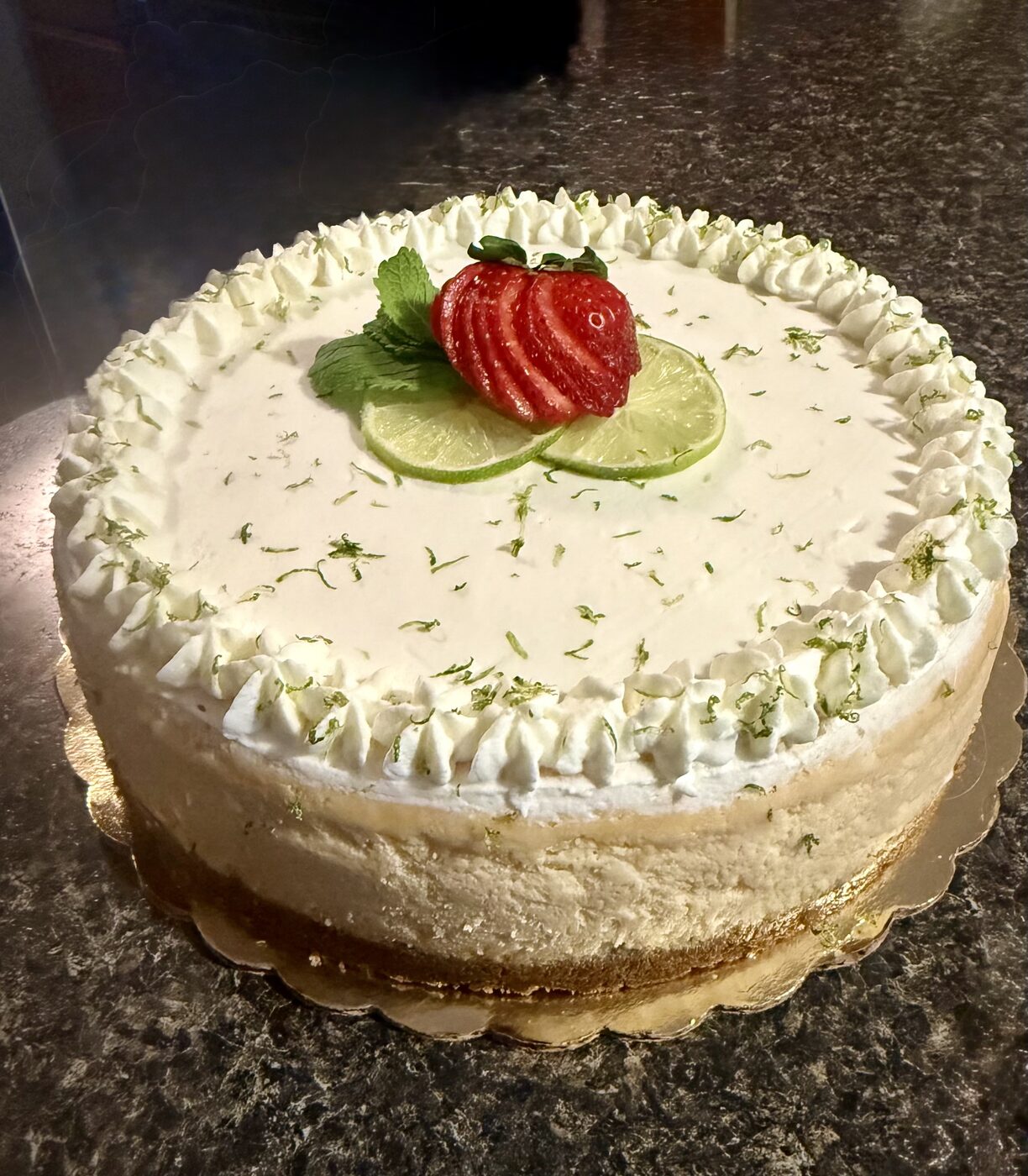 Key lime cheesecake with strawberry garnish