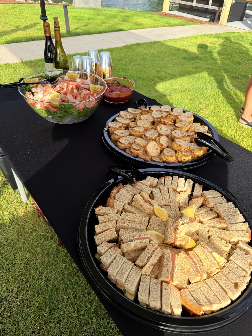 Lakeside party spread with shrimp, crostini and tea sandwiches